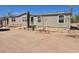 View of a single-story home with neutral paint, desert landscaping, and a satellite dish at 52150 W Cardinal S Rd, Maricopa, AZ 85139