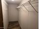 Bright walk-in closet with wood-look floors and metal shelving at 52150 W Cardinal S Rd, Maricopa, AZ 85139
