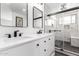 Stylish bathroom with double vanity, modern fixtures, and a walk-in shower with glass door at 5325 W Desert Hills Dr, Glendale, AZ 85304