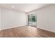 Bright, empty room with wood floors and sliding glass doors leading to the outdoor swimming pool at 5325 W Desert Hills Dr, Glendale, AZ 85304