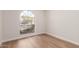 Bedroom with wood floors, light walls, and a window providing natural light at 5325 W Desert Hills Dr, Glendale, AZ 85304