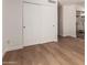 Bedroom with wood flooring and closet, leading into a bathroom with vanity and tiled shower at 5325 W Desert Hills Dr, Glendale, AZ 85304
