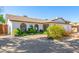 Single-story home featuring desert landscaping, white brick, and a convenient two-car garage at 5325 W Desert Hills Dr, Glendale, AZ 85304