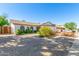 Single-story home featuring desert landscaping, white brick, and a convenient two-car garage at 5325 W Desert Hills Dr, Glendale, AZ 85304