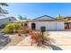 Charming single-story home with a well-manicured lawn and a classic white brick facade at 5325 W Desert Hills Dr, Glendale, AZ 85304