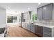 Modern kitchen features quartz counters, stainless appliances, gray cabinetry, and tile backsplash at 5325 W Desert Hills Dr, Glendale, AZ 85304