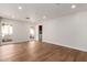 Hardwood flooring in living space with bright white walls and natural light from the backyard at 5325 W Desert Hills Dr, Glendale, AZ 85304