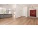 Open-concept living space with hardwood floors, a kitchen view, and a striking red front door at 5325 W Desert Hills Dr, Glendale, AZ 85304