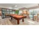 Billiard room with pool table, decorative art, and views of the pool through the windows at 5450 E Deer Valley Dr # 2003, Phoenix, AZ 85054