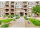 Exterior view of a multi-story apartment building with well-maintained landscaping at 5450 E Deer Valley Dr # 2003, Phoenix, AZ 85054