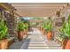 Picturesque covered walkway lined with potted plants and stone pillars leads to a serene water feature at 5450 E Deer Valley Dr # 2003, Phoenix, AZ 85054