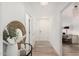 Hallway features decorative mirror, modern chandelier, and wood-look floors at 5450 E Deer Valley Dr # 2003, Phoenix, AZ 85054