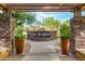 Gorgeous water feature framed by stone pillars and vibrant plants creates a tranquil outdoor space at 5450 E Deer Valley Dr # 2003, Phoenix, AZ 85054