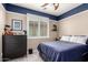 bedroom with blue accent, ceiling fan and plantation shutters creating a cozy and stylish space at 5622 W Cavedale Dr, Phoenix, AZ 85083