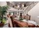 Elegant dining room featuring a large chandelier, staircase, and an ornate dining table at 5622 W Cavedale Dr, Phoenix, AZ 85083