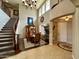 Grand foyer with soaring ceilings, a curved staircase, and elegant decor, creating a welcoming entrance at 5622 W Cavedale Dr, Phoenix, AZ 85083