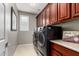 Functional laundry room equipped with modern washer and dryer, storage cabinets, and ample counter space at 5622 W Cavedale Dr, Phoenix, AZ 85083