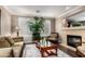 Inviting living room with a fireplace, sofa, and plants create a warm atmosphere at 5622 W Cavedale Dr, Phoenix, AZ 85083