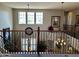 Elegant loft area with wrought iron railings, high ceilings and natural light from large windows at 5622 W Cavedale Dr, Phoenix, AZ 85083