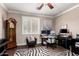 Well-lit home office featuring a desk, monitors, and an antique grandfather clock at 5622 W Cavedale Dr, Phoenix, AZ 85083