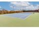 Well-maintained tennis court with blue and green surface, surrounded by fencing, offering a recreational amenity at 5622 W Cavedale Dr, Phoenix, AZ 85083