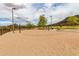 Outdoor sand volleyball court with net and benches, a perfect spot for fun recreational games in the community at 5622 W Cavedale Dr, Phoenix, AZ 85083
