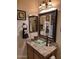 Bathroom featuring a vessel sink, granite countertop, and decorative mirrors at 6372 W Hill Ln, Glendale, AZ 85310