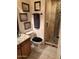 Bathroom featuring a vessel sink, granite countertop, toilet, and glass shower at 6372 W Hill Ln, Glendale, AZ 85310