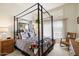 Charming bedroom featuring a four-poster bed, natural light, and stylish decor at 6372 W Hill Ln, Glendale, AZ 85310