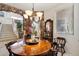 Elegant dining room featuring a stone archway and a wooden table with a decorative chandelier at 6372 W Hill Ln, Glendale, AZ 85310