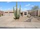 Contemporary home with a desert landscaped front yard and large Saguaro cactus at 6372 W Hill Ln, Glendale, AZ 85310
