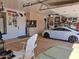 Well-organized garage with storage cabinets, epoxy flooring, and a sleek sports car at 6372 W Hill Ln, Glendale, AZ 85310
