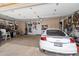 Spacious garage with car, workbench, and plenty of storage space; ideal for projects at 6372 W Hill Ln, Glendale, AZ 85310
