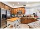 Spacious kitchen with wooden cabinetry, stainless steel appliances, and a butcher block island at 6372 W Hill Ln, Glendale, AZ 85310