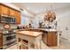 Well-equipped kitchen featuring wood cabinets, stainless steel appliances, and a convenient center island at 6372 W Hill Ln, Glendale, AZ 85310