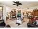Inviting living room featuring a stone fireplace, plush seating, and an open layout to the kitchen at 6372 W Hill Ln, Glendale, AZ 85310