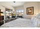 Bright main bedroom featuring a large window, patio access, and a cozy sitting area at 6372 W Hill Ln, Glendale, AZ 85310