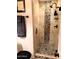 Close up on the glass shower featuring decorative stone tiles and modern fixtures at 6372 W Hill Ln, Glendale, AZ 85310