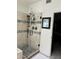 Walk-in shower featuring decorative stone tiles and a glass enclosure at 6372 W Hill Ln, Glendale, AZ 85310