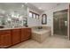 Luxurious bathroom with soaking tub, glass-enclosed shower, dual vanity, and ample counter space at 7600 E Golden Eagle Cir, Gold Canyon, AZ 85118