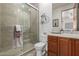 Bathroom boasts a glass shower, decorative bike art, spacious countertop, and under-sink cabinet at 7600 E Golden Eagle Cir, Gold Canyon, AZ 85118