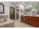 Elegant bathroom featuring soaking tub, glass shower, large mirror and custom vanity at 7600 E Golden Eagle Cir, Gold Canyon, AZ 85118