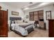 This bedroom contains wood floors, a study desk and chair, and natural light at 7600 E Golden Eagle Cir, Gold Canyon, AZ 85118