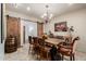 Well-lit dining room with rustic chandelier, unique table and large sliding barn doors at 7600 E Golden Eagle Cir, Gold Canyon, AZ 85118