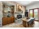 Elegant dining room featuring a stone accent wall with fireplace and wood table at 7600 E Golden Eagle Cir, Gold Canyon, AZ 85118