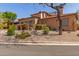 Charming single-Gathering home with a well-manicured front yard and gravel landscaping at 7600 E Golden Eagle Cir, Gold Canyon, AZ 85118