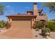 Spacious two-car garage with an attractive driveway and lush landscaping at 7600 E Golden Eagle Cir, Gold Canyon, AZ 85118