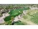 Aerial view of lush golf course with manicured greens and mature trees at 7600 E Golden Eagle Cir, Gold Canyon, AZ 85118