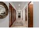 Inviting hallway with hardwood floors, stylish mirror, and access to bedrooms and bathrooms at 7600 E Golden Eagle Cir, Gold Canyon, AZ 85118
