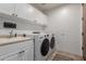 Laundry room with white cabinets, countertops, sink, washer, and dryer at 7600 E Golden Eagle Cir, Gold Canyon, AZ 85118